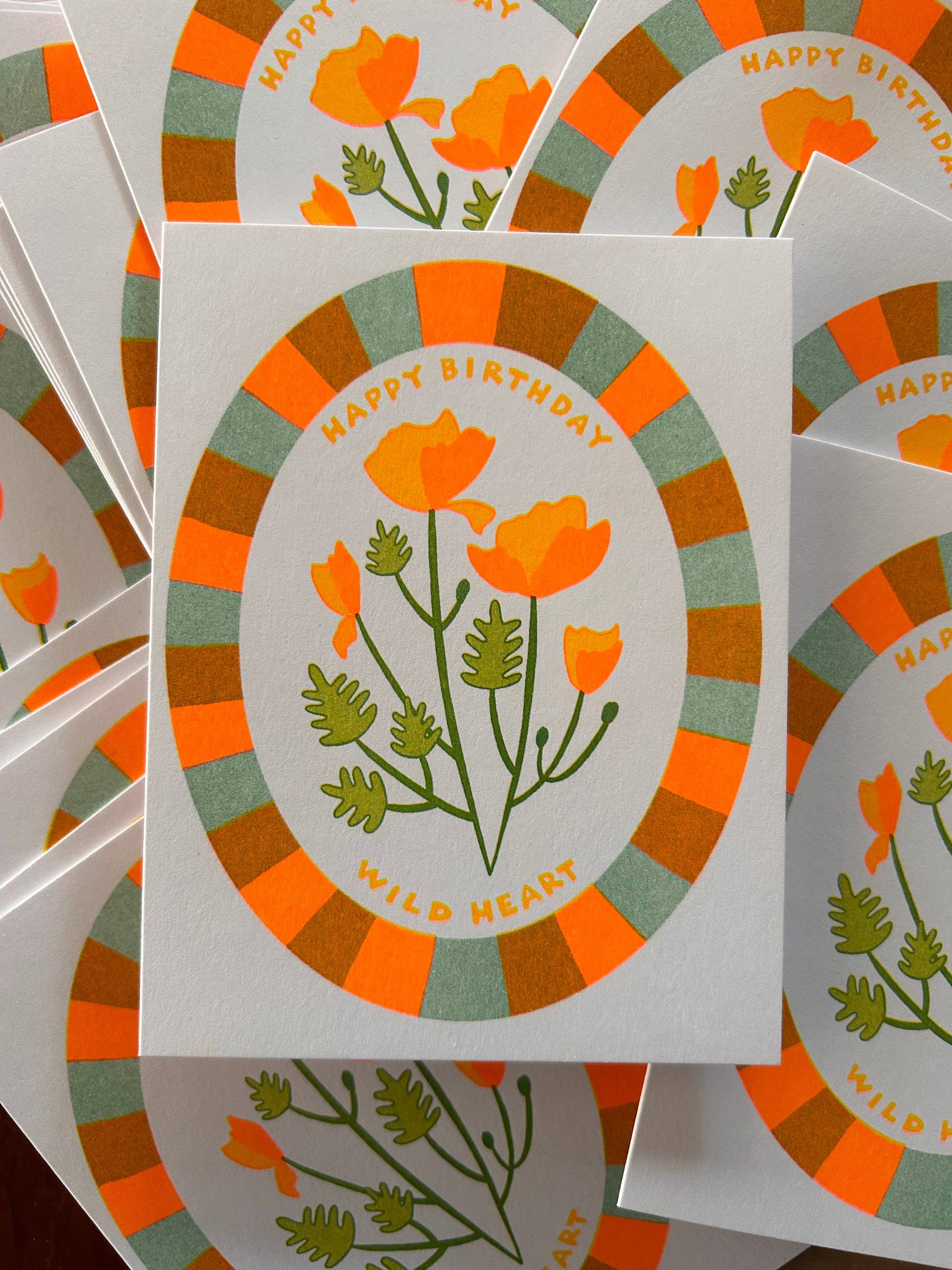 Stack of birthday cards with floral design and 'Happy Birthday' text