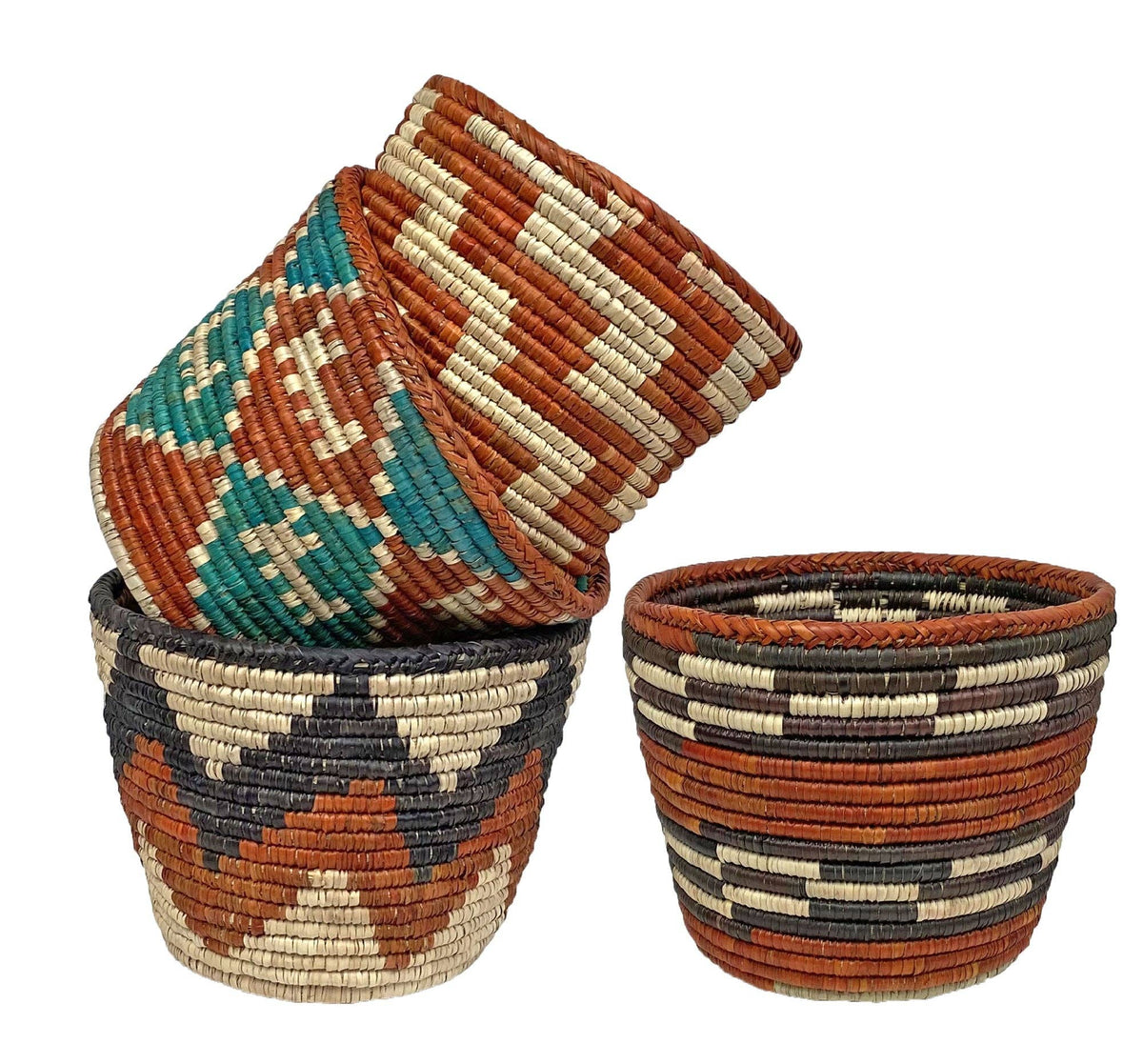 Three handwoven baskets in rust, teal and black patterns stacked and side by side on a white background