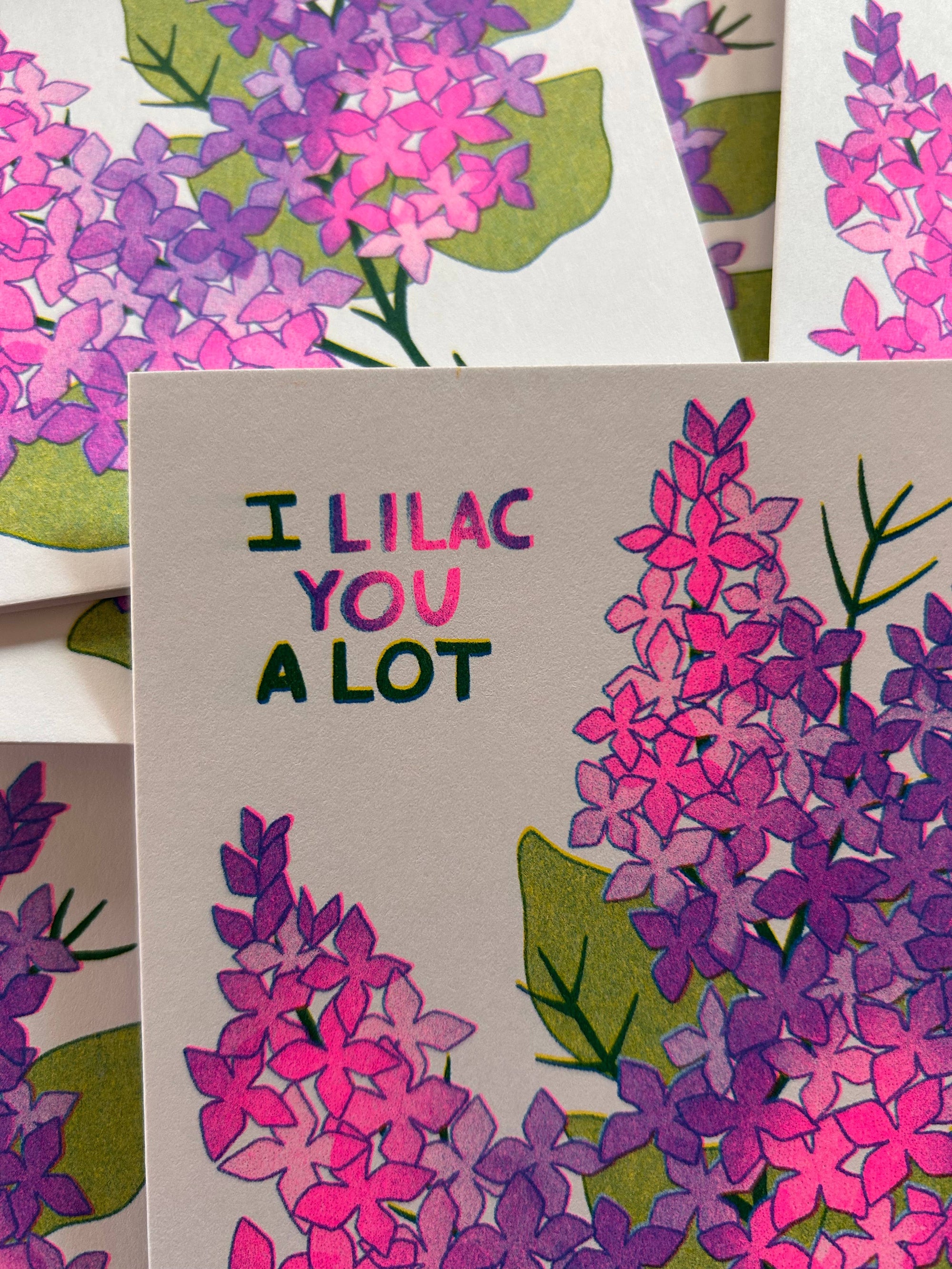 Card with 'I Lilac You A Lot' text surrounded by lilac flower illustrations.