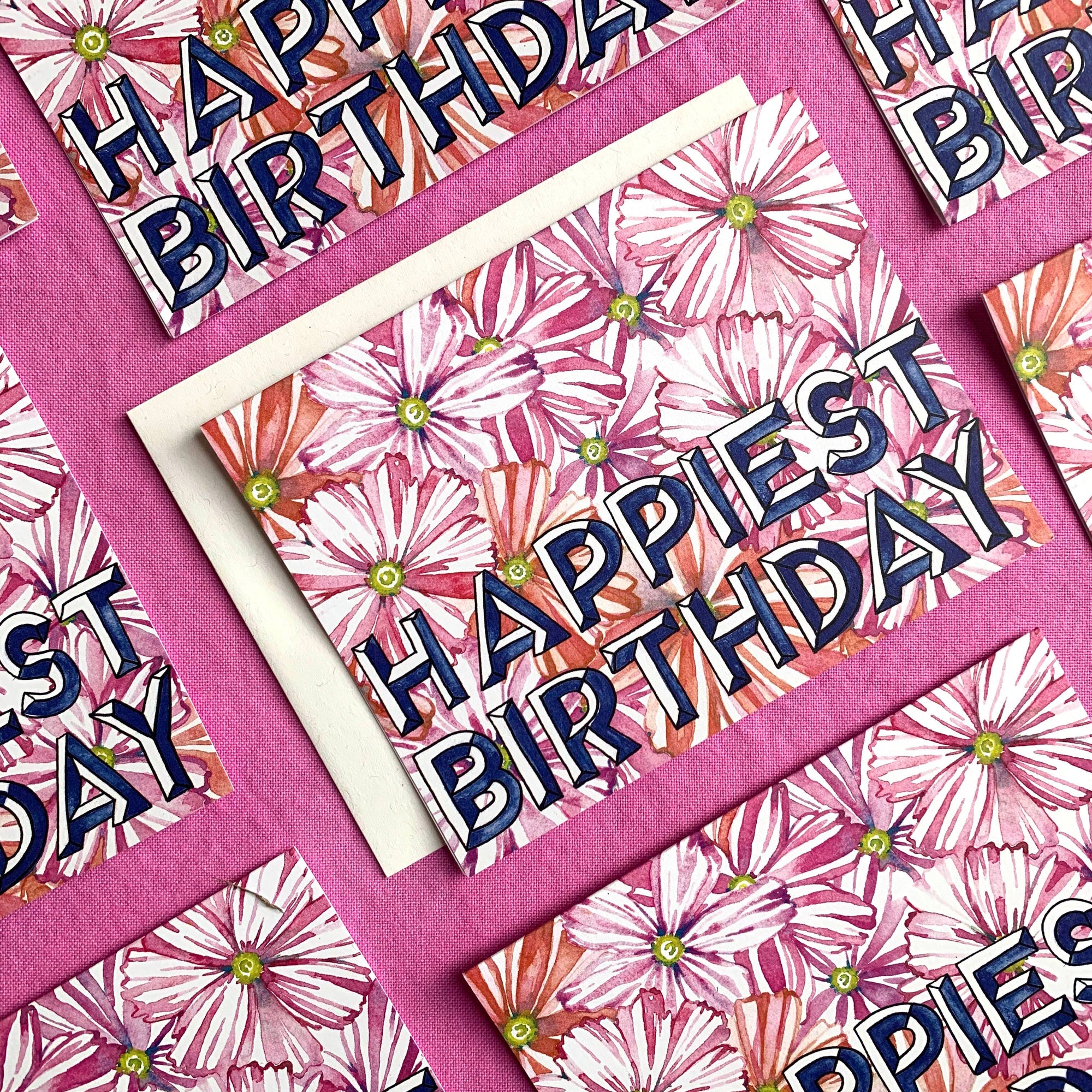Birthday card with floral design and 'Happy Birthday' text on a pink background