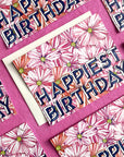 Birthday card with floral design and 'Happy Birthday' text on a pink background