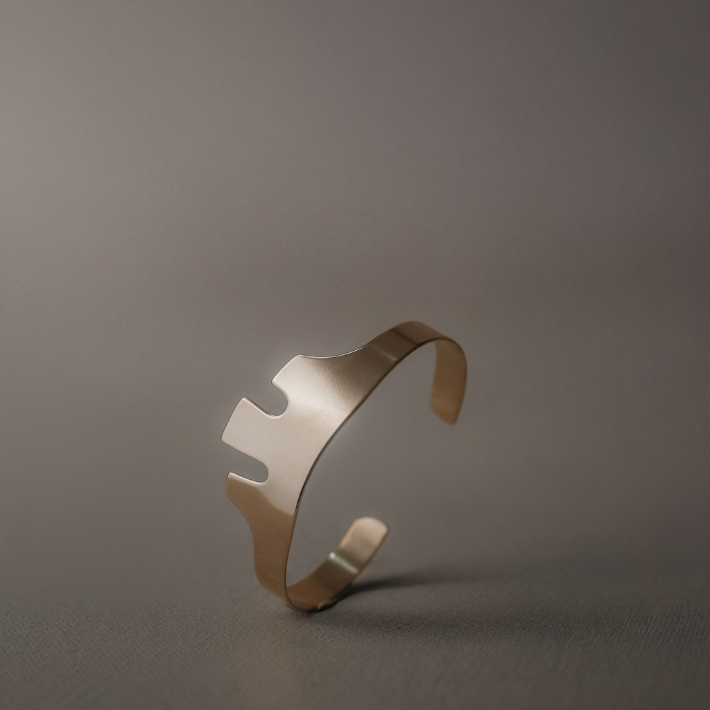 A handcrafted sculptural cuff bracelet featuring an abstract cut-out design inspired by modern art and vintage jewelry. Available in solid brass or sterling silver, this statement cuff combines bold geometric shapes with clean lines for an effortlessly modern look