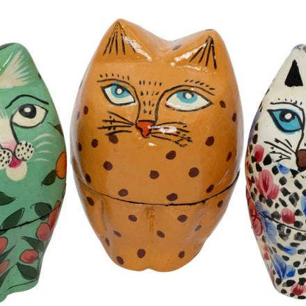 Three hand-painted wooden cat-shaped nesting boxes on a plain white background, each with a different colorful floral and pattern design.