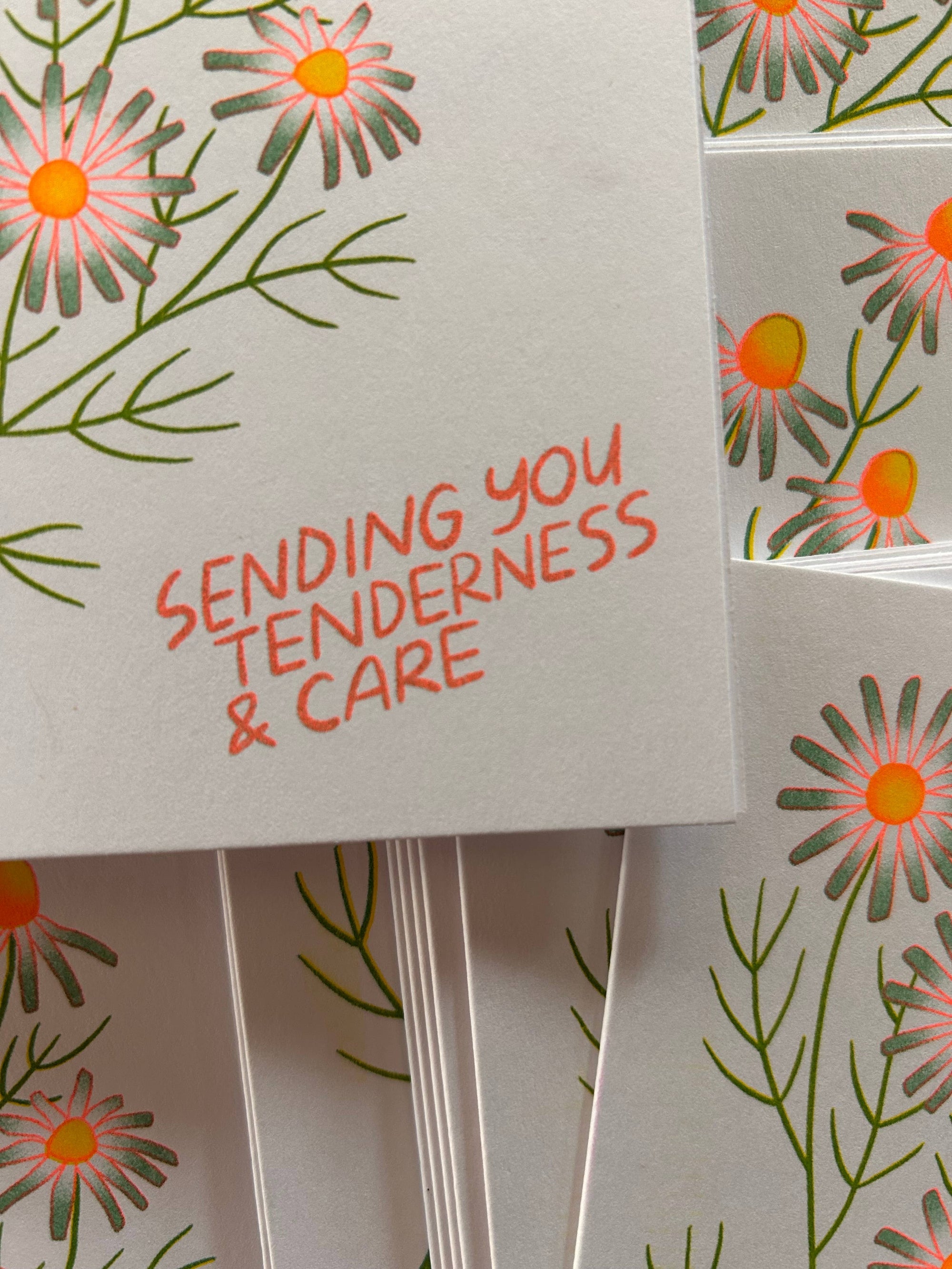 Card with floral design and text 'Sending you tenderness &amp; care' on a matching background.