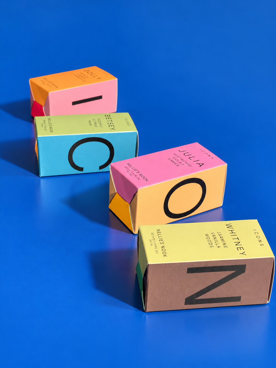 Icons perfume boxes laid out to spell ICON on a blue background