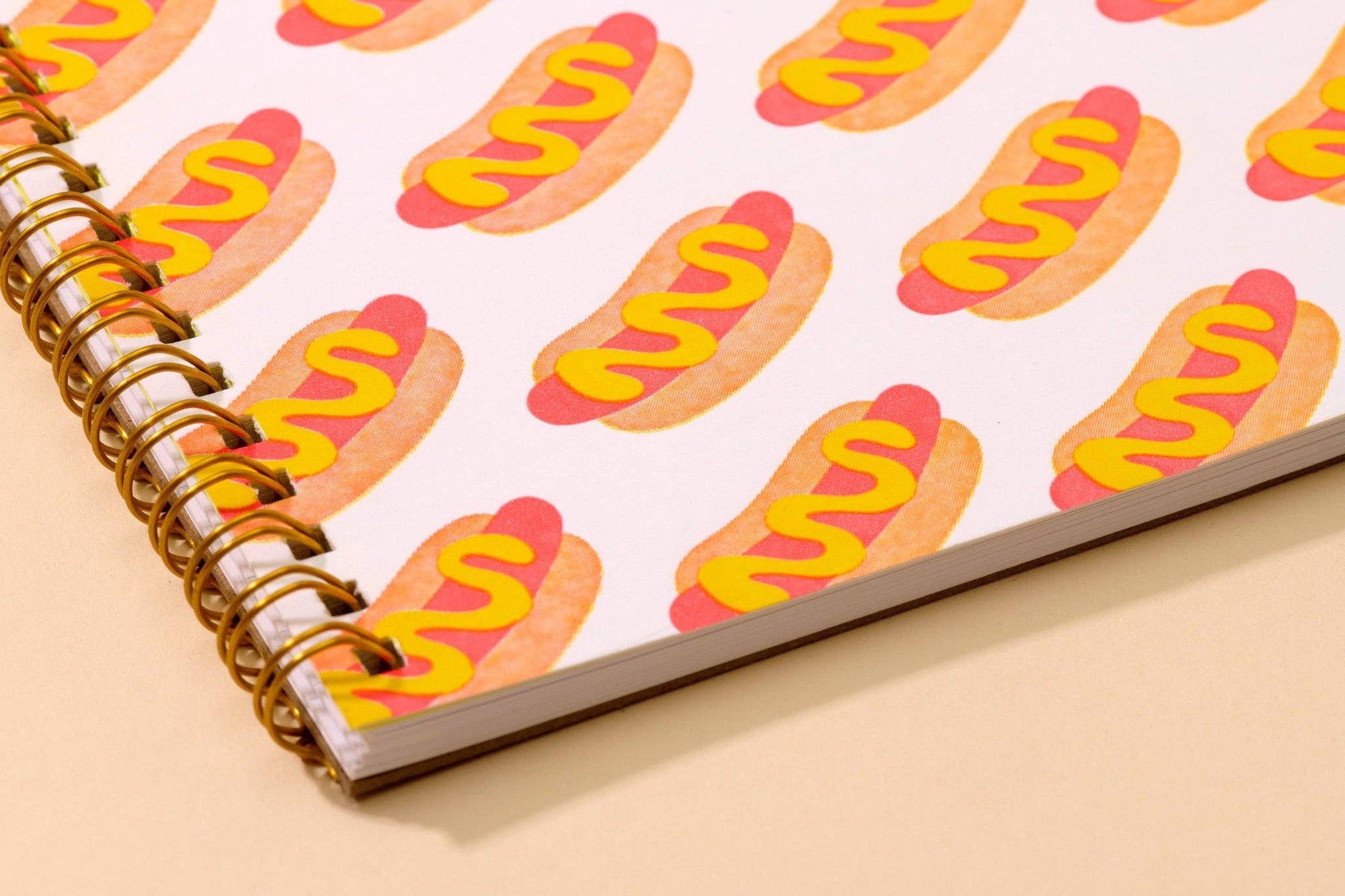 Hot dog A5 spiral notebook with letterpress cover and 48 lined pages. A fun and functional pick for food lovers. Made in the USA with recycled paper.