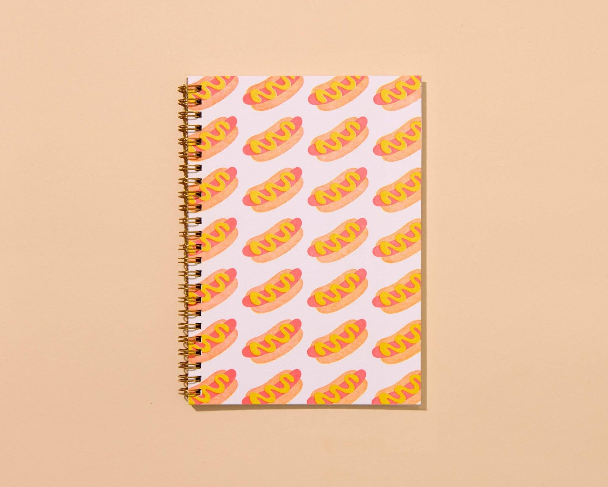 Hot dog A5 spiral notebook with letterpress cover and 48 lined pages. A fun and functional pick for food lovers. Made in the USA with recycled paper.
