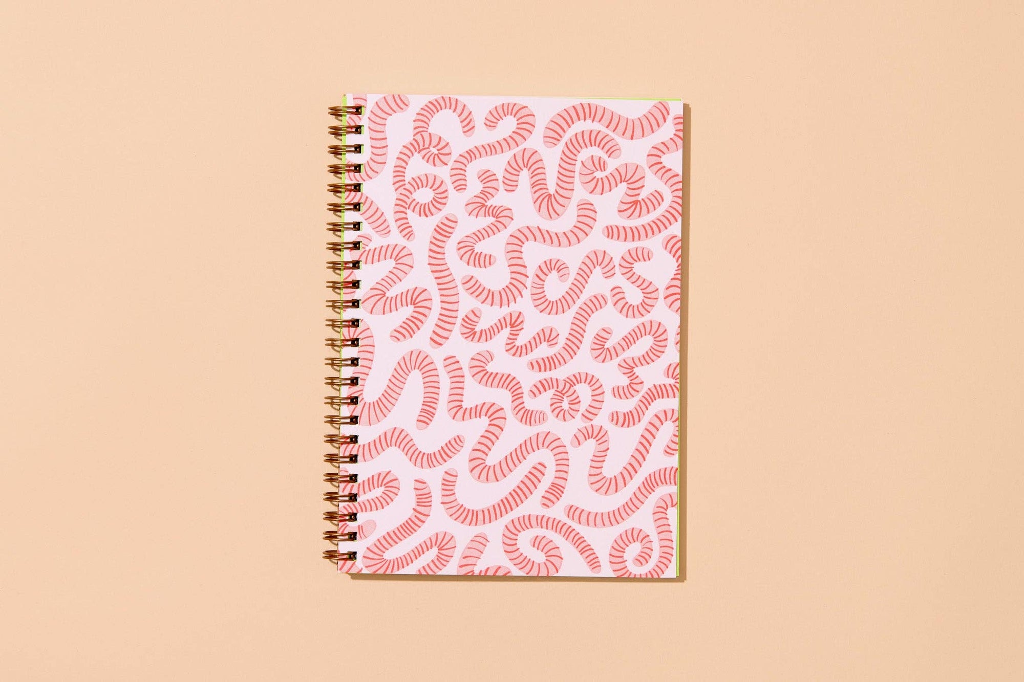 Unlock your inner child with this delightfully wiggly worm notebook. Featuring a quirky worm pattern on a letterpress printed cover, this A5 spiral notebook is just the right size for lists, doodles, and garden daydreams.