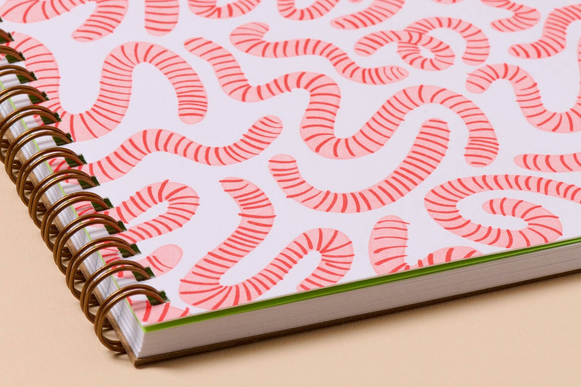Unlock your inner child with this delightfully wiggly worm notebook. Featuring a quirky worm pattern on a letterpress printed cover, this A5 spiral notebook is just the right size for lists, doodles, and garden daydreams.