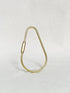 Brass teardrop key ring with a screw bar standing on a white surface