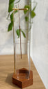 Upside-down incense holder with a clear glass tube on a small wooden base