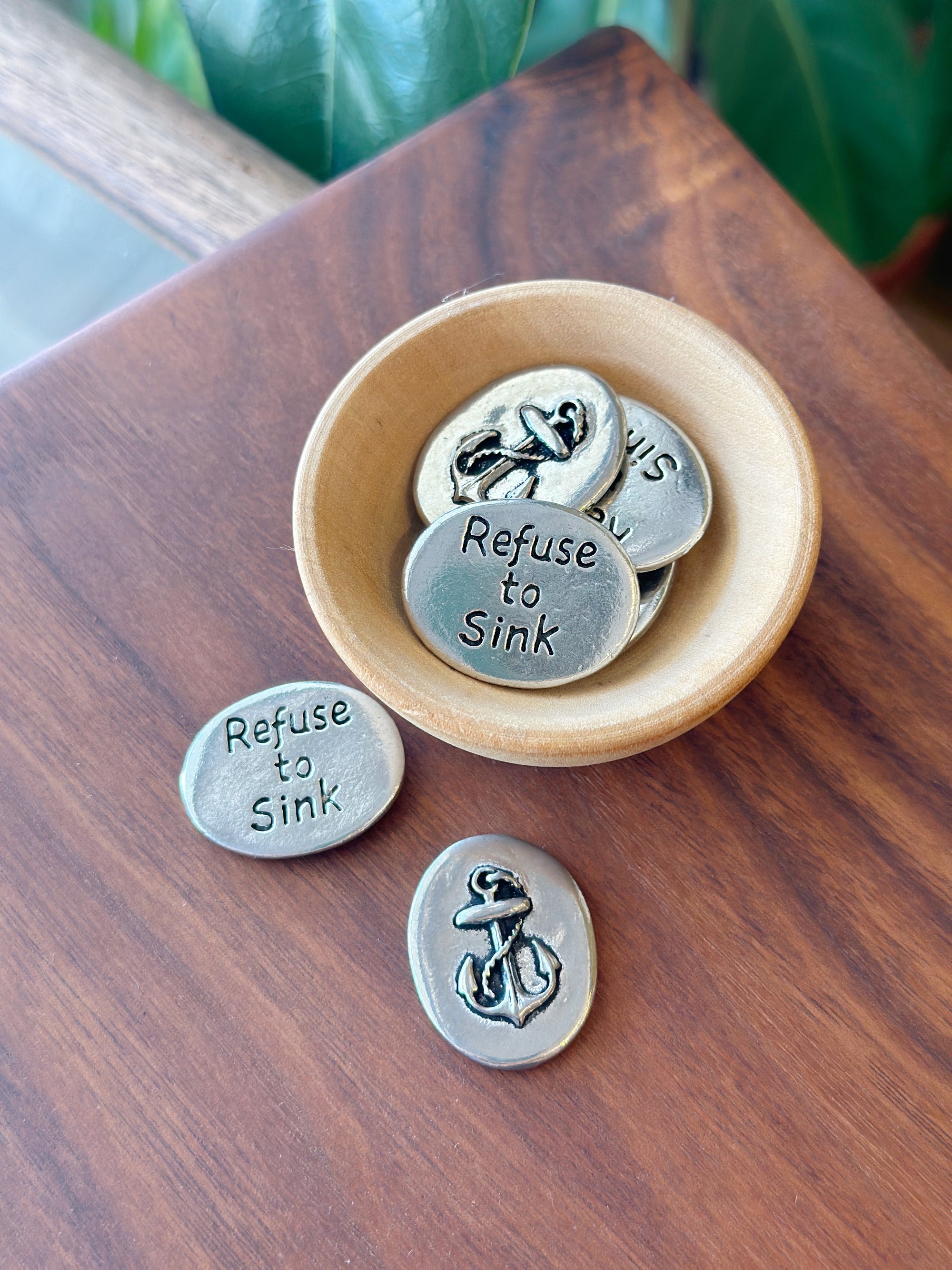 This anchor coin is the perfect little addition to carry around in your bag or decorate spaces around your home. The front of the coin features an anchor and the back of the coin reads "refuse to sink", reminding us to never give up hope. This coin isn't just cute decor, it's got a message to get across!

Fine hand-crafted pewter, made in Canada.