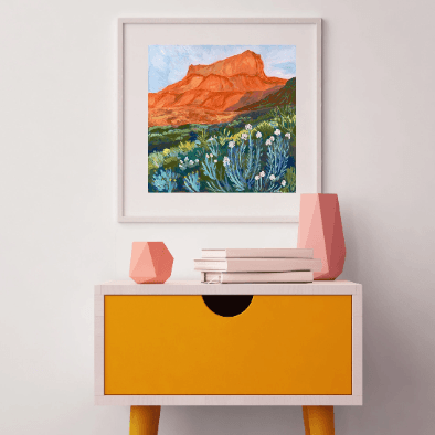 Catch a West Texas sunset without leaving your living room. This vibrant 12 x 12 inch art print by Austin artist&nbsp;El Baker captures the glowing red cliffs and wild desert blooms of Big Bend National Park. The bold brushstrokes and warm hues bring the landscape to life, evoking the magic of golden hour in one of Texas’s most iconic parks.

This high-quality fine art giclée print highlights the rich color and texture of the original painting. Created on thick, durable matte paper, each museum-quality art 