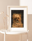Framed portrait of a dog on a white table against a beige wall