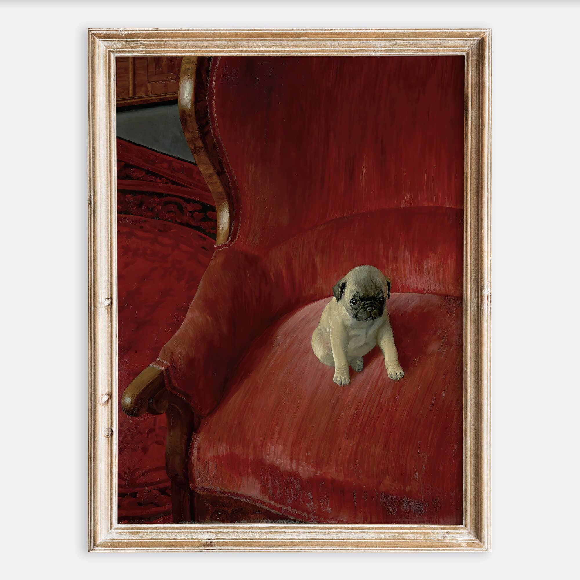 Framed artwork of a pug puppy on a red velvet chair