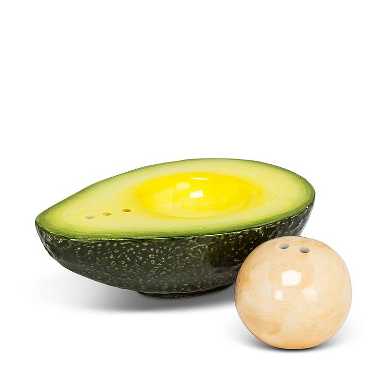 Spice up guacamole and so much more with this realistic-looking Avocado and Pit Salt &amp; Pepper Shaker set. Crafted out of ceramic, this beautifully painted faux-avocado and pit look just like the real thing — the perfect complement to any Mexican-food lover's dining table.