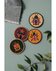 Set of 4 beaded coasters featuring unique beetle designs from Danica Studio’s Amulet collection. Made with glass beads and durable fabric for everyday use.