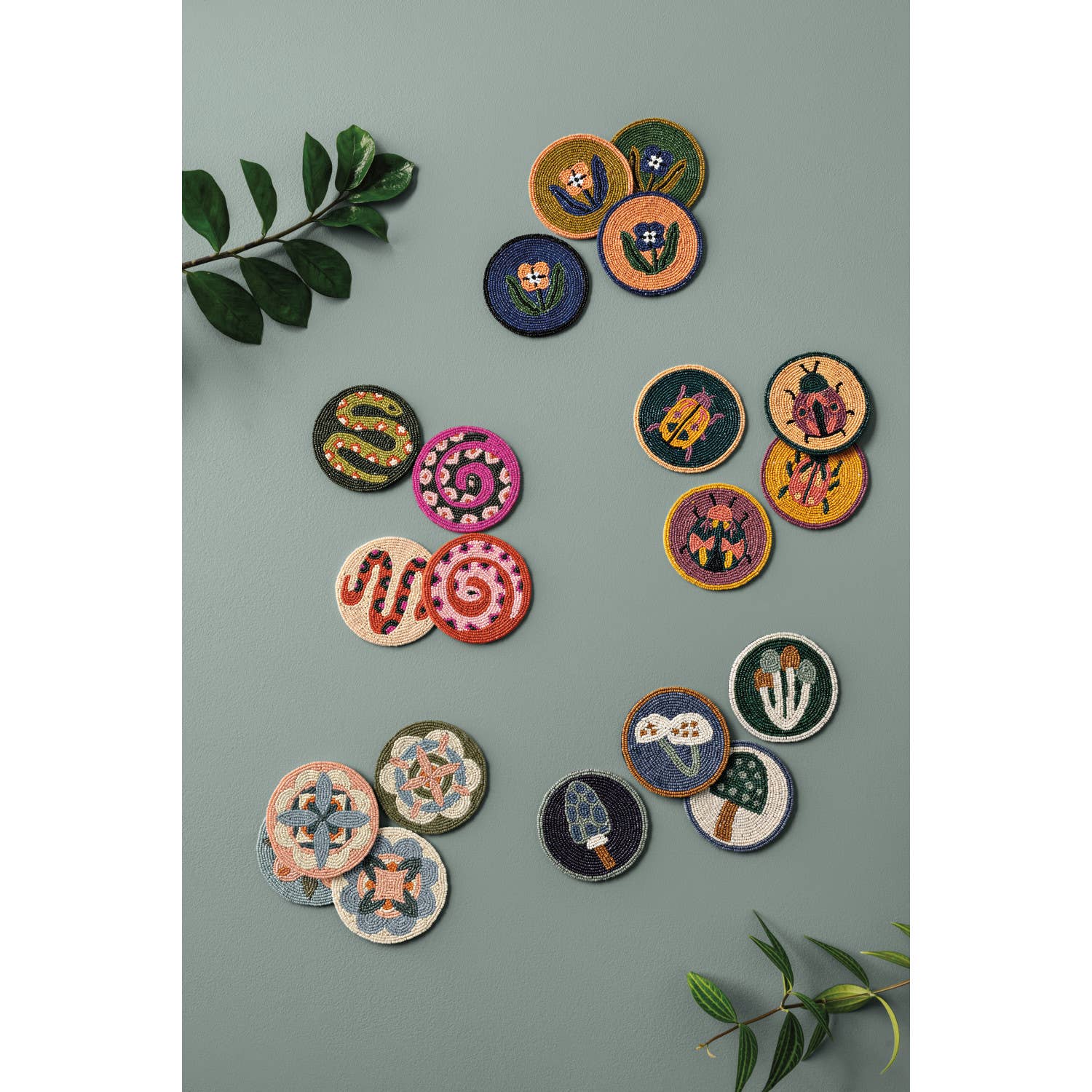 Set of 4 beaded coasters featuring unique beetle designs from Danica Studio’s Amulet collection. Made with glass beads and durable fabric for everyday use.