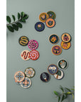 Set of 4 beaded coasters featuring unique beetle designs from Danica Studio’s Amulet collection. Made with glass beads and durable fabric for everyday use.