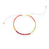 Red and chartreuse glass bead bracelet on an adjustable silk cord on white