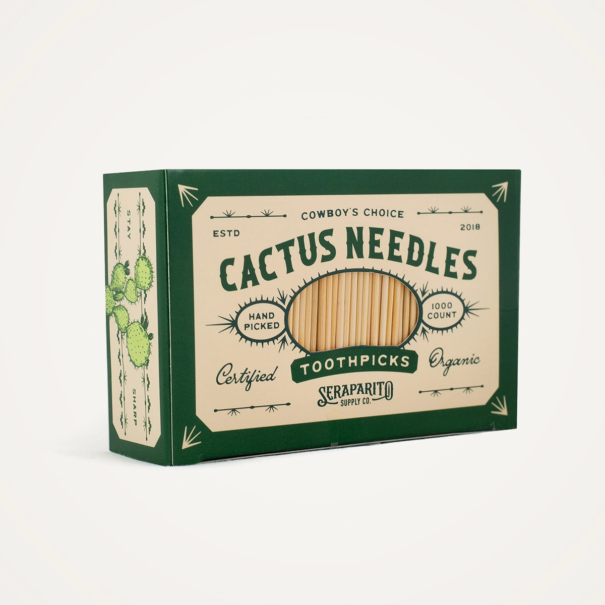 Box of Cactus Needles toothpicks with green and beige design on a white background