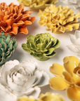 Colorful ceramic flower sculptures on a light background