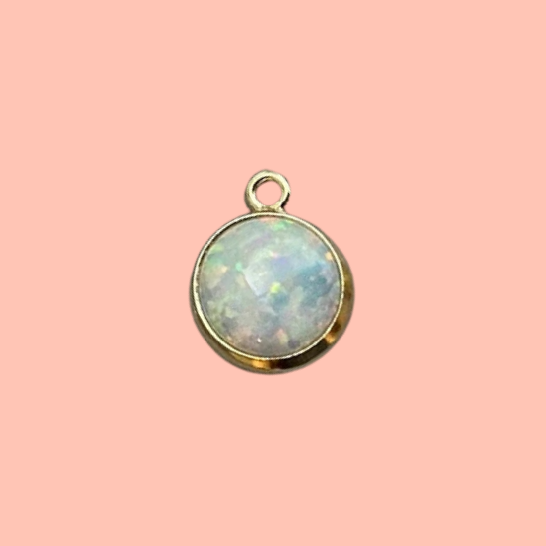 A little shimmer that catches every light. Our 14k gold-filled bezel-set synthetic opal charm glows with a dreamy iridescent swirl of pink, blue, and green — subtle, ethereal, and endlessly wearable. This petite premium charm adds a timeless accent that layers beautifully with both sentimental and playful pieces in any charm bar creation.