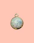 A little shimmer that catches every light. Our 14k gold-filled bezel-set synthetic opal charm glows with a dreamy iridescent swirl of pink, blue, and green — subtle, ethereal, and endlessly wearable. This petite premium charm adds a timeless accent that layers beautifully with both sentimental and playful pieces in any charm bar creation.