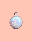 Opal pendant with silver setting on a pink background