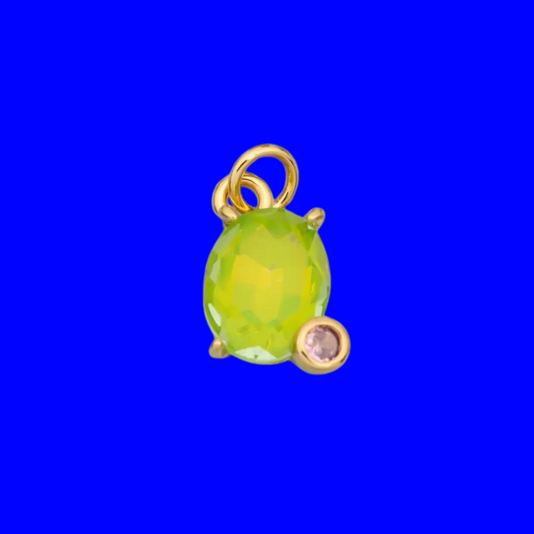 Bright, luminous, and full of personality. This charm features a large faceted peridot colored crystal set in a classic prong setting, accented by a dainty bezel-set crystal nestled at the side for an unexpected touch of elegance. A vibrant statement piece for any charm bracelet, necklace, or earring, pairing beautifully with both premium gold-filled pieces and colorful novelty charms.
