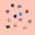 Birthstone connector charms in sterling silver, in assorted gem colors on a pink background