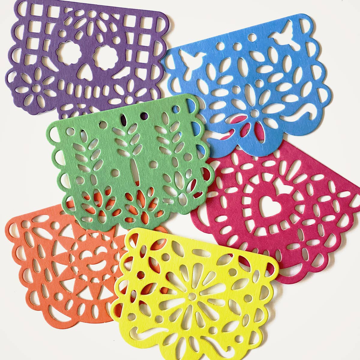 Add fiesta flair with Papel Picado Coasters! Bright, intricate, and fun, these festive paper coasters protect surfaces while bringing color to any celebration.