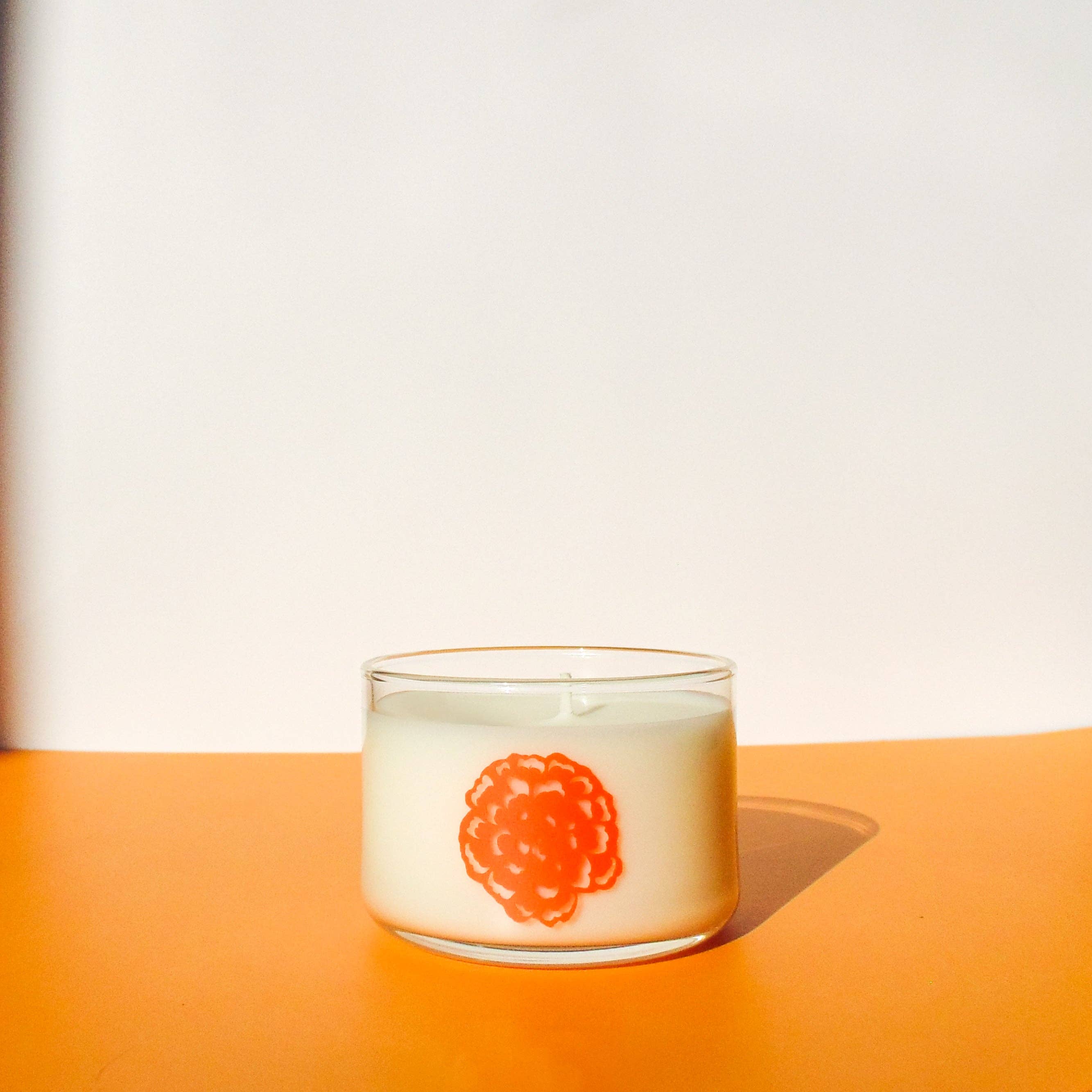 Ofrenda Coconut Soy Candle blends mahogany, marigold, and bergamot—a warm unisex scent honoring Día de los Muertos tradition.