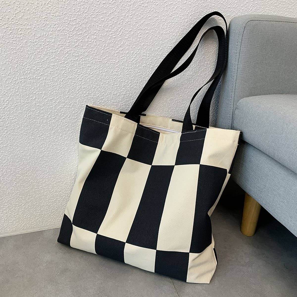 This black and white canvas tote brings a bold, modern feel to your everyday essentials. The striking colorblock design adds visual flair, while the sturdy canvas construction makes it a reliable pick for workdays, errands, or quick weekend adventures. Simple, graphic, and easy to carry, it’s a timeless staple with a fresh twist.