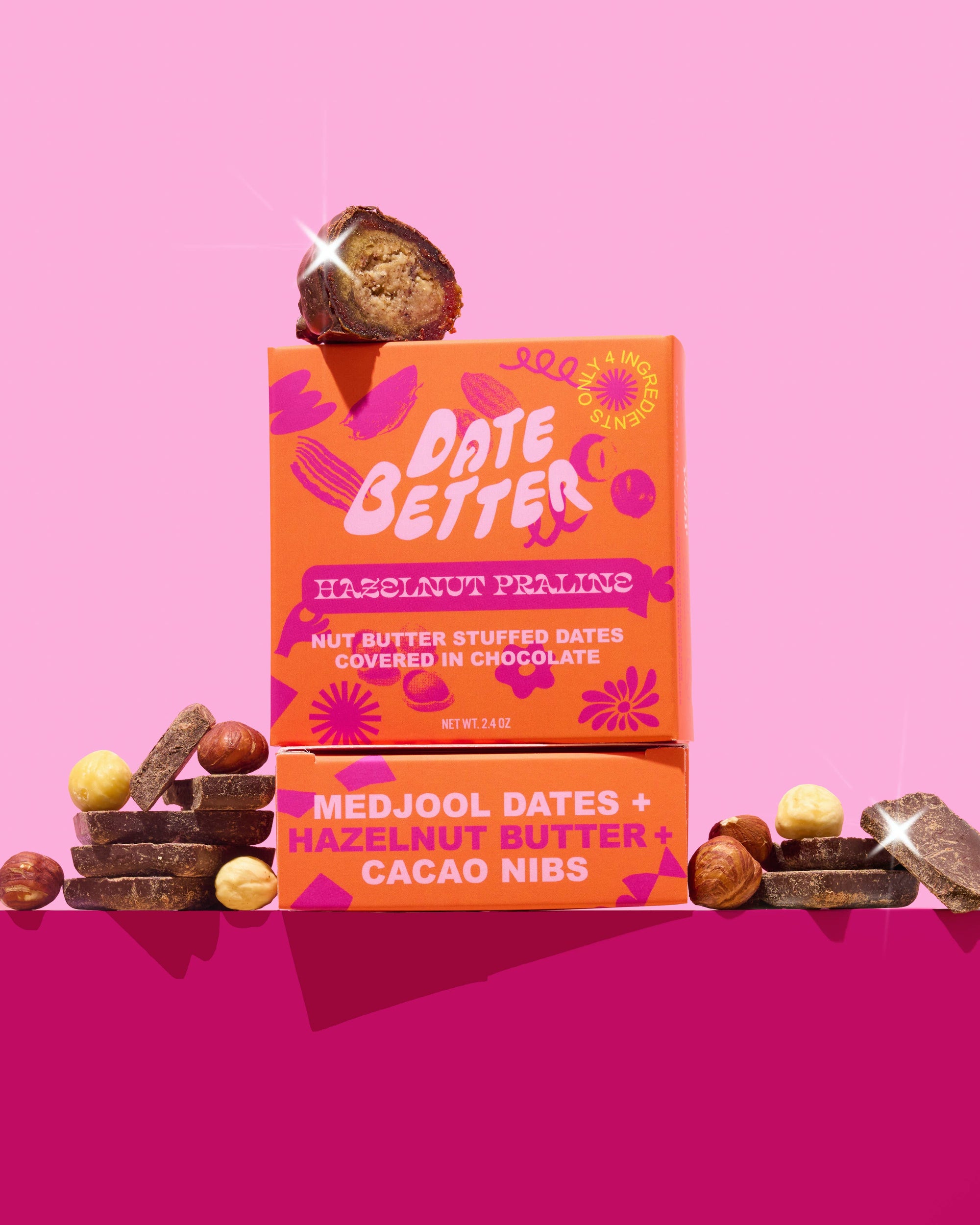 Orange packaging of 'Date Better' with dates and hazelnuts on a pink background