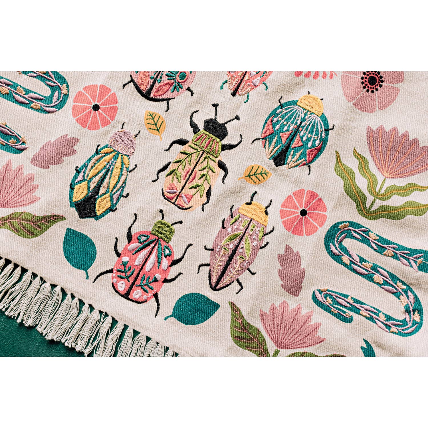 Add charm and protection to your kitchen with the Amulet Embroidered Dishtowel. Featuring insects, reptiles, flowers, and feathers in vibrant hues with playful tassels.