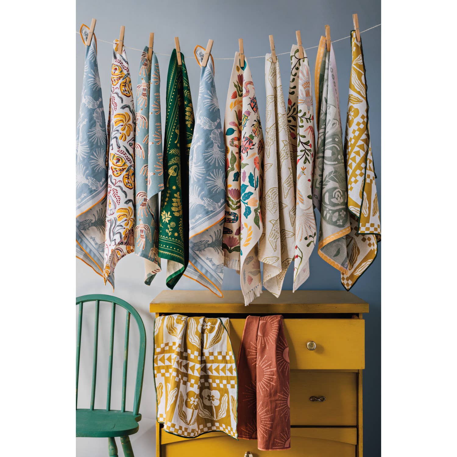 Add charm and protection to your kitchen with the Amulet Embroidered Dishtowel. Featuring insects, reptiles, flowers, and feathers in vibrant hues with playful tassels.
