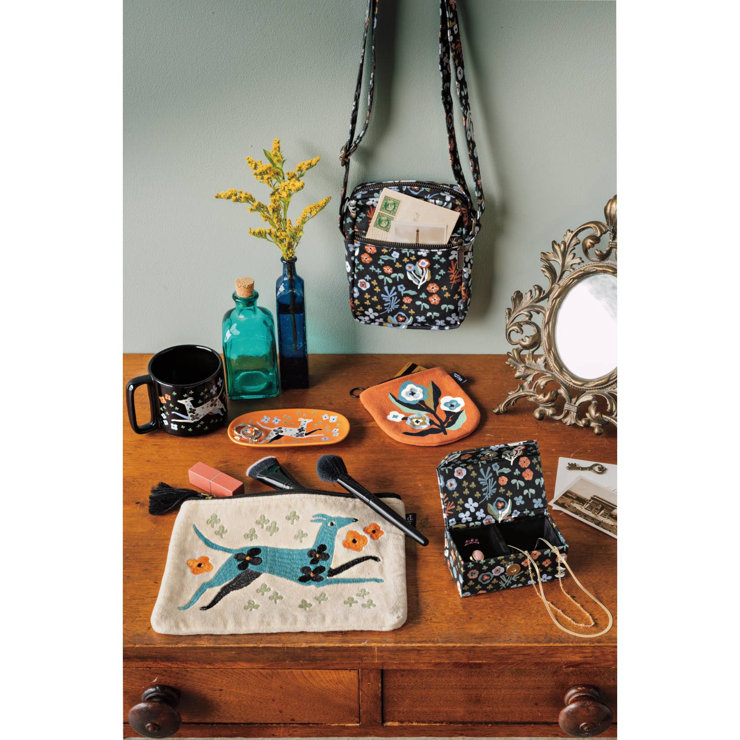 Collection of handcrafted bags and pouches on a wooden surface with decorative items.