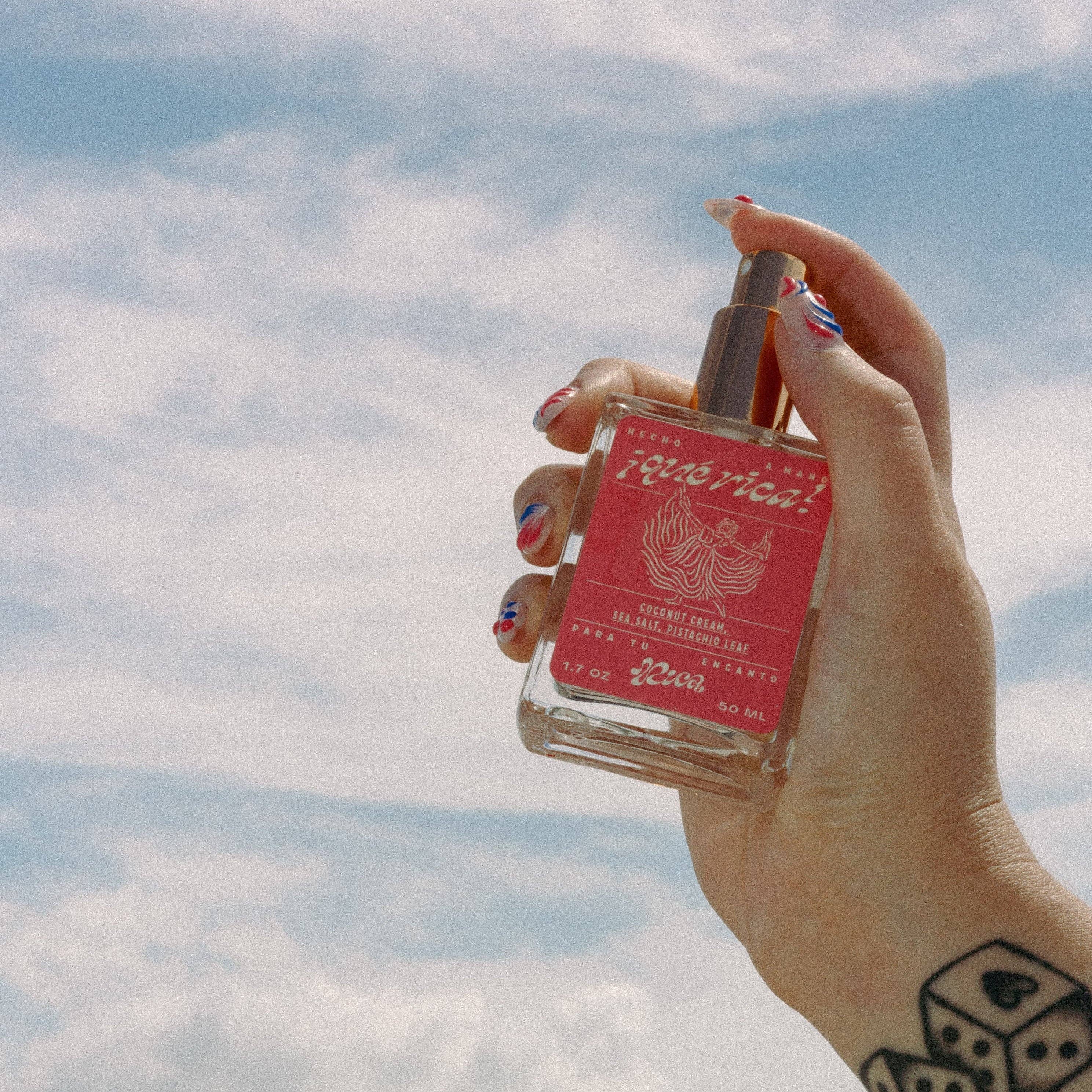 Dive into the sultry allure of ¡Qué Rica!—an eau de parfum that strikes the perfect balance of sweet and salty. This perfume mist is derived from essential oils and crafted to transport you with every spritz.

Top Notes: Coconut cream, sea salt, citrus zest
Middle Notes: Vanilla crème, jasmine blossom
Base Notes: Sandalwood, amber, cedar