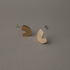 Pair of brass half-circle stud earrings on a gray background