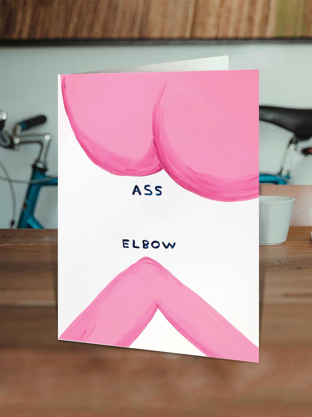 Turn some heads (and elbows) with the Ass Elbow Greeting Card, featuring the hilariously bold artwork of David Shrigley. Perfect for everyday laughs or just sending a little mischief, this card is blank inside so you can add your own punchline—or let Shrigley’s cheeky humor do the talking.