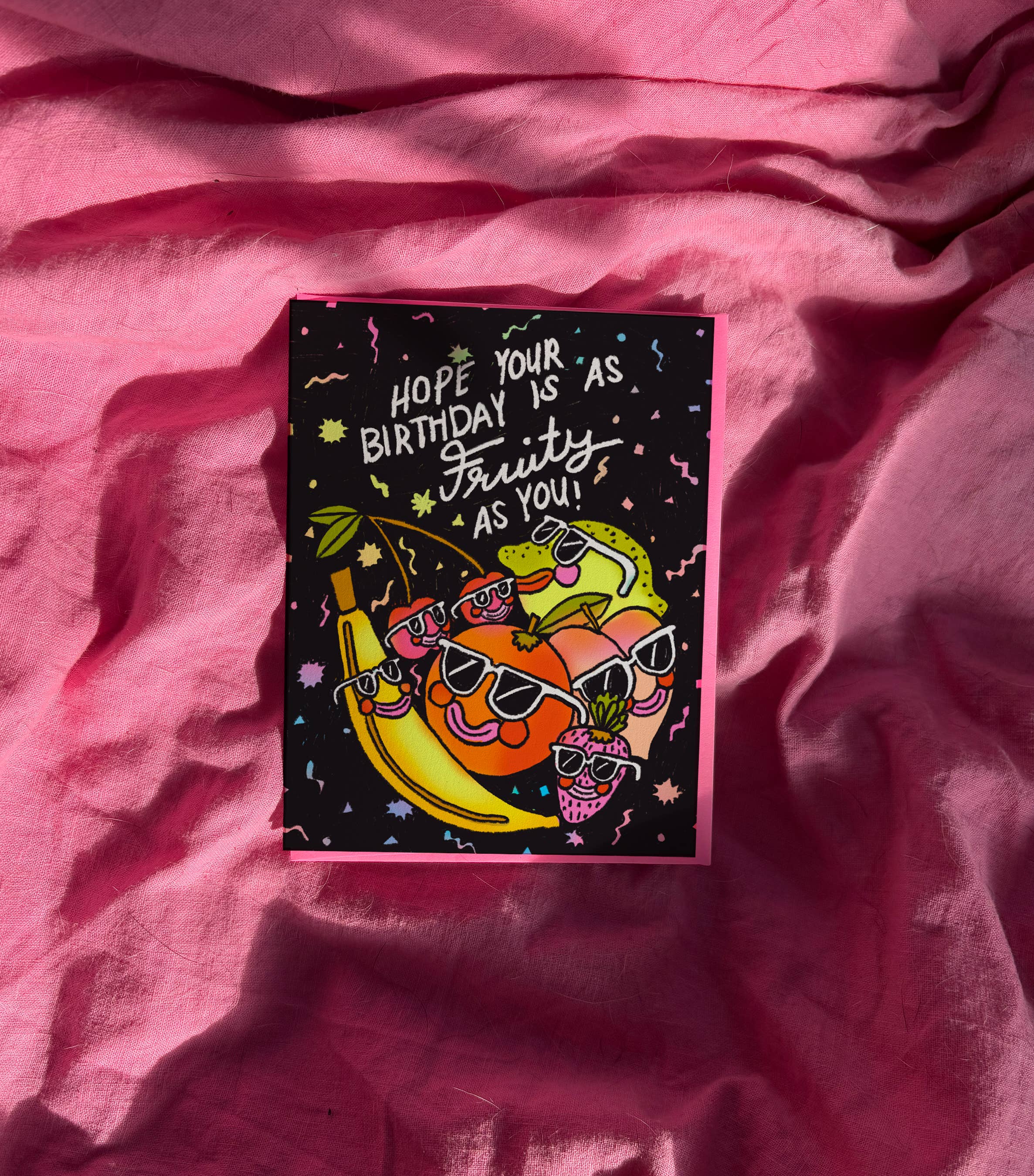 Colorful birthday card with cartoon characters on a pink fabric background