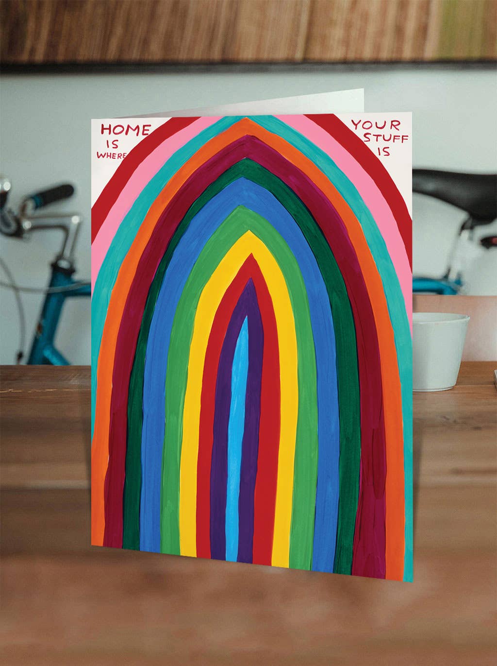 Show off your love for all things cozy (and cluttered) with the Home Is Where Your Stuff Is Greeting Card, featuring the delightfully quirky artwork of David Shrigley. Perfect for housewarmings, birthdays, or just a little everyday humor, this card is blank inside so you can write your own witty note—or let the art do the talking.