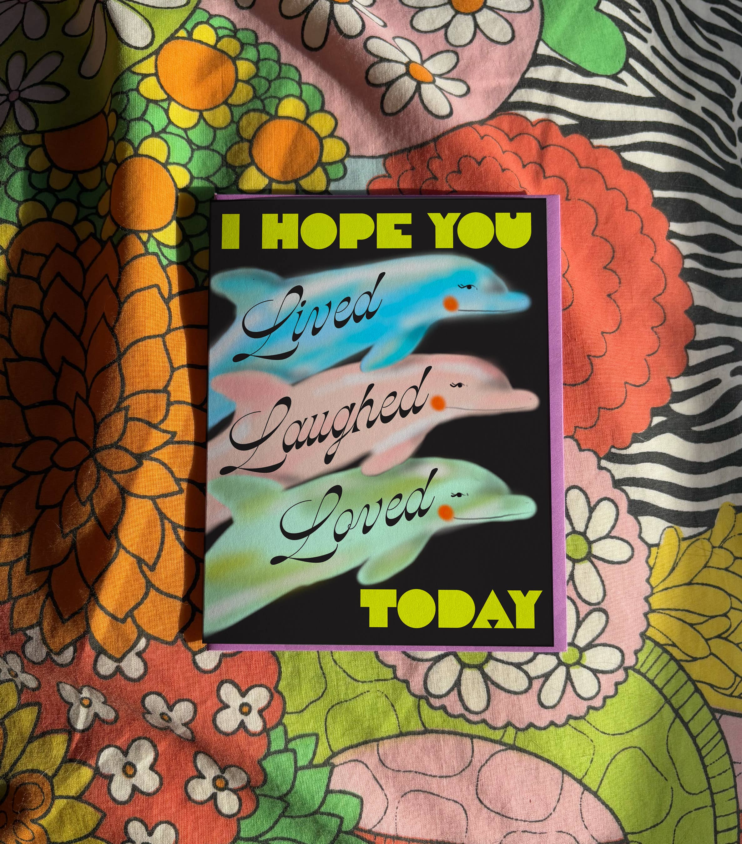Colorful fabric with a motivational card featuring dolphins and text.