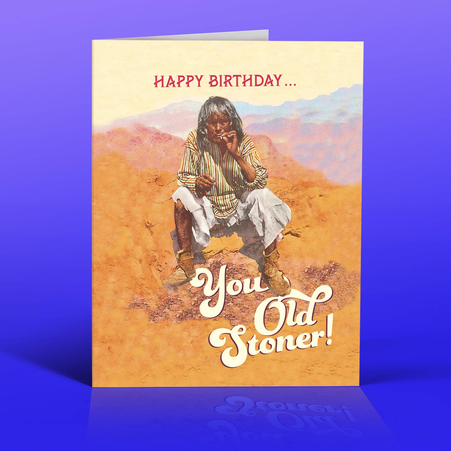 Birthday card with a person smoking and text 'Happy Birthday... You Old Stoner!' on a desert background.
