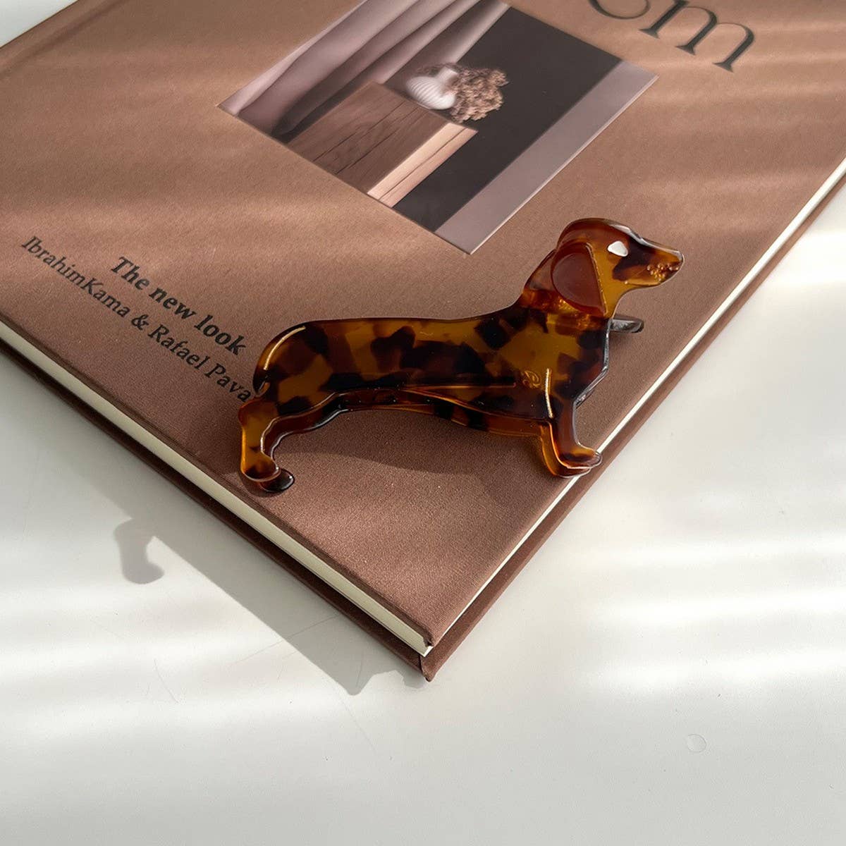 Show off your love for pups with this dachshund-shaped hair claw clip. Crafted from smooth brown acetate, it’s lightweight and easy to wear, keeping hair in place while adding a playful, whimsical touch to any look. Perfect for dog lovers or anyone who enjoys fun, animal-inspired accessories.