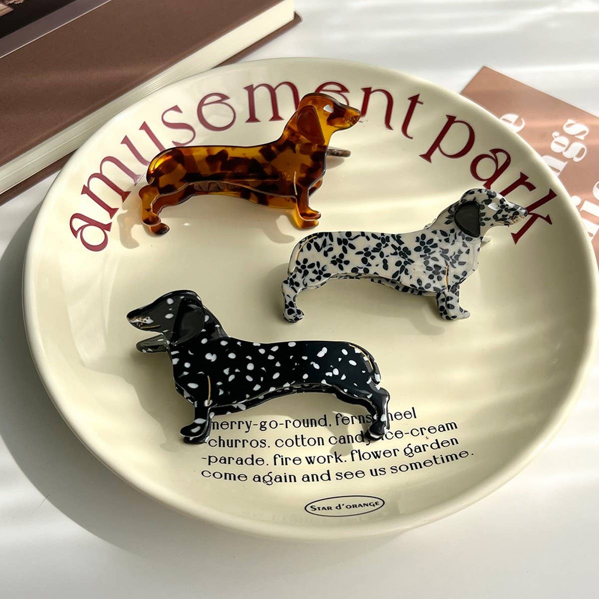 Show off your love for pups with this dachshund-shaped hair claw clip. Crafted from smooth brown acetate, it’s lightweight and easy to wear, keeping hair in place while adding a playful, whimsical touch to any look. Perfect for dog lovers or anyone who enjoys fun, animal-inspired accessories.