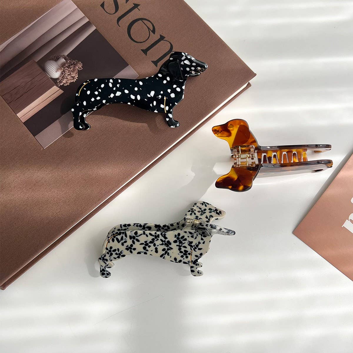 Show off your love for pups with this dachshund-shaped hair claw clip. Crafted from smooth brown acetate, it’s lightweight and easy to wear, keeping hair in place while adding a playful, whimsical touch to any look. Perfect for dog lovers or anyone who enjoys fun, animal-inspired accessories.