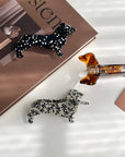 Show off your love for pups with this dachshund-shaped hair claw clip. Crafted from smooth brown acetate, it’s lightweight and easy to wear, keeping hair in place while adding a playful, whimsical touch to any look. Perfect for dog lovers or anyone who enjoys fun, animal-inspired accessories.
