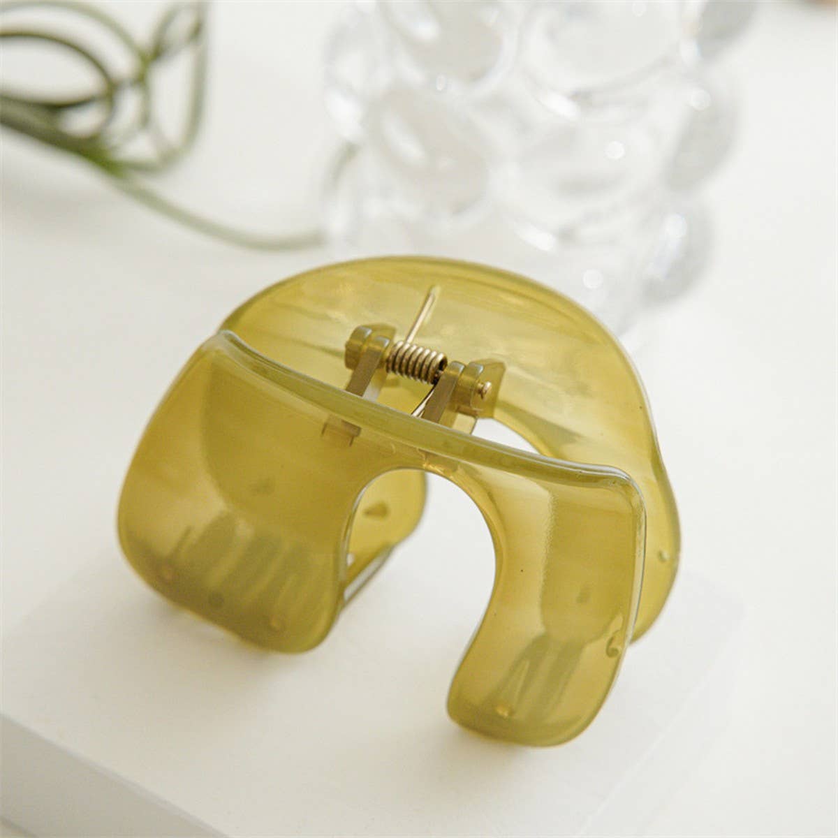 Add a subtle pop of color with this minimalist jelly green hair claw clip. Lightweight and easy to wear, it keeps hair in place while adding a soft, modern touch to any look. Perfect for everyday styling or layering with other clips for a chic, trendy vibe.